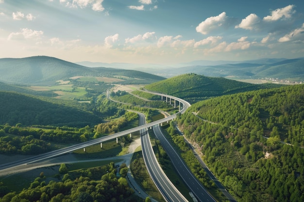 Photo aerial view of highway bridge connecting towns over green valley