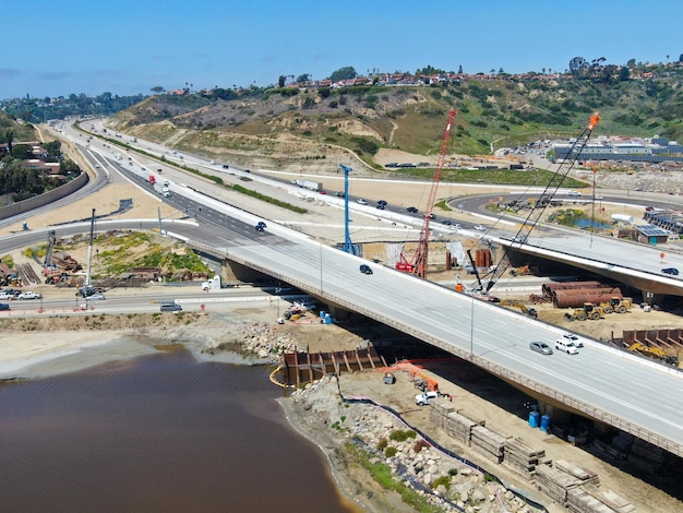 Aerial view of highway bridge construction over small river San Diego California USA