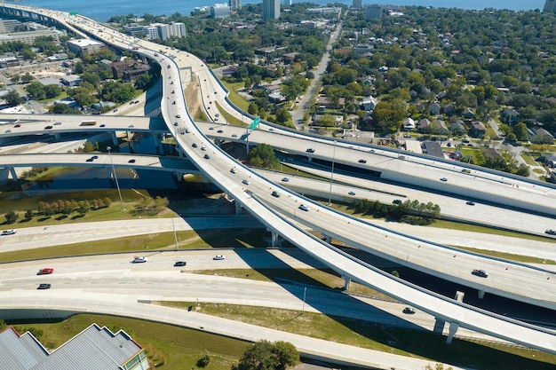 Aerial view of highway overpass with moving traffic cars and trucks