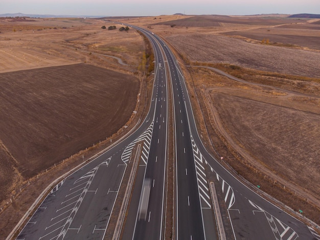 Aerial view of highway road at sunset in autumn Top view from drone of road