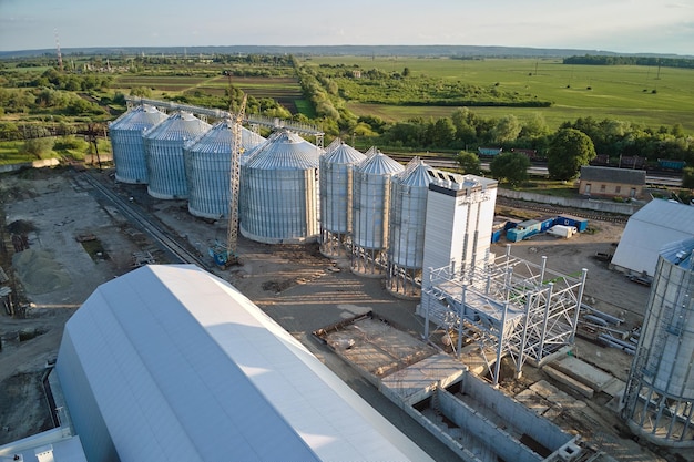 Aerial view of industrial ventilated silos for long term storage of grain and oilseed Metal elevator for wheat drying in agricultural zone