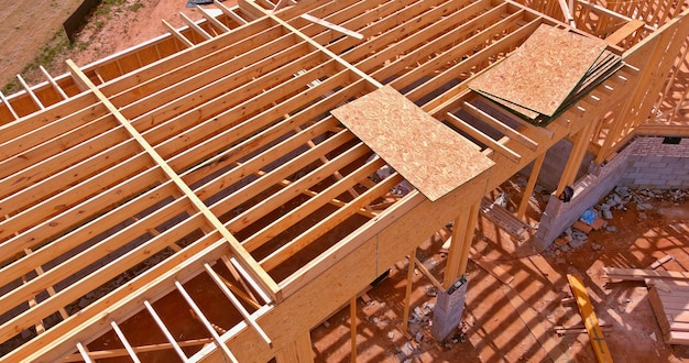 Aerial view a installation of wooden beams at construction the roof truss system of the house