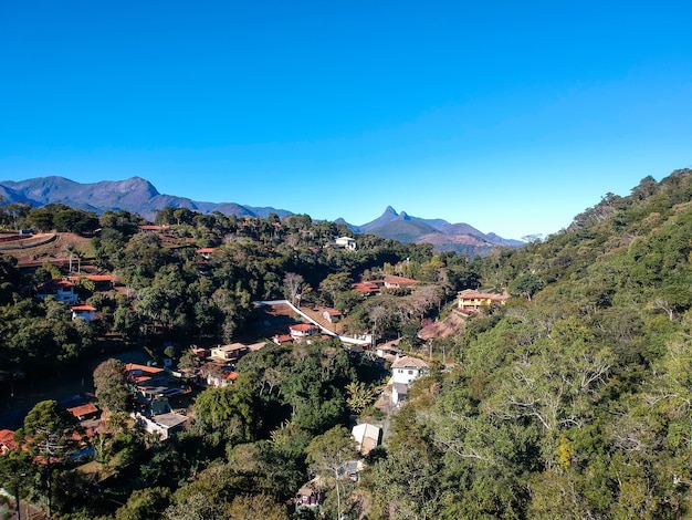 Aerial view of Itaipava, PetrÃ³polis. Mountains with blue sky and some clouds around PetrÃ³polis, mountainous region of Rio de Janeiro, Brazil. Drone photo. Sunny day.