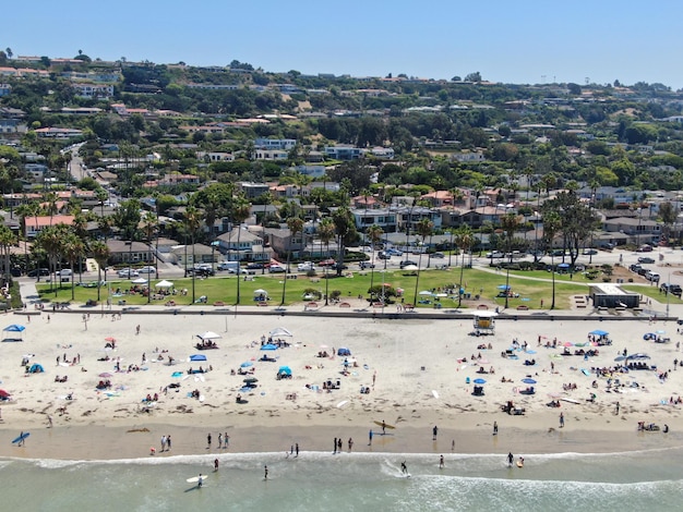 Aerial view of La Jolla bay with nice small waves and tourist enjoying the beach day