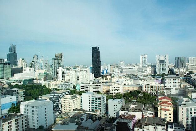 Aerial view landscape cityscape of bangkok city and high building tower condominium with thai people driving riding biking on street and traffic road busy jam on August 25 2022 in Bangkok Thailand