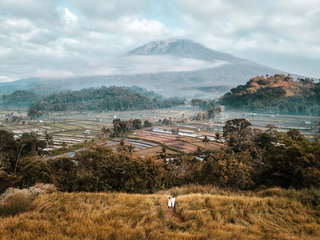 Aerial view of landscape Couple with Terrace rice field of Mount Agung volcano in Bali in Indonesia