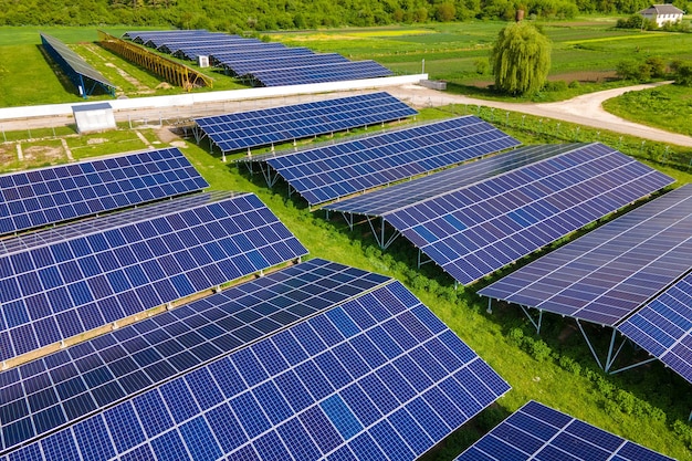 Aerial view of large sustainable electrical power plant with rows of solar photovoltaic panels for producing clean ecological electric energy. Renewable electricity with zero emission concept.