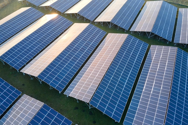 Aerial view of large sustainable electrical power plant with rows of solar photovoltaic panels for producing clean ecological electric energy Renewable electricity with zero emission concept