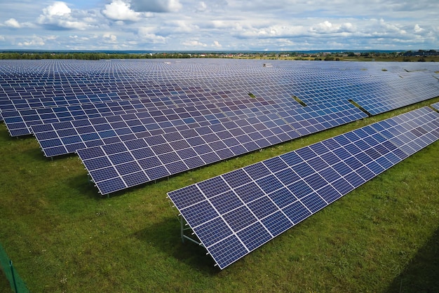 Aerial view of large sustainable electrical power plant with rows of solar photovoltaic panels for producing clean electric energy Concept of renewable electricity with zero emission