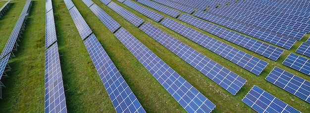 Aerial view of large sustainable electrical power plant with rows of solar photovoltaic panels for producing clean electric energy Concept of renewable electricity with zero emission