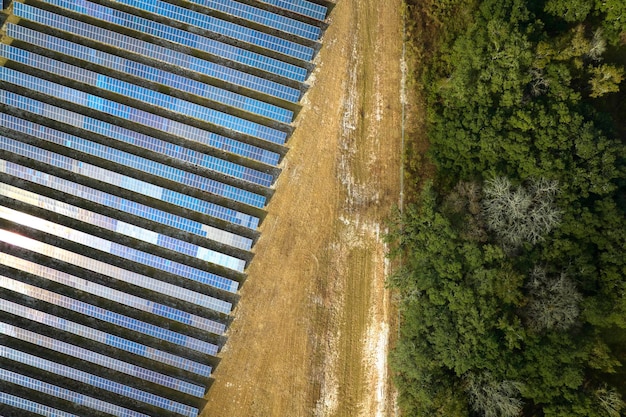 Aerial view of large sustainable electrical power plant with rows of solar photovoltaic panels for producing clean electric energy Concept of renewable electricity with zero emission