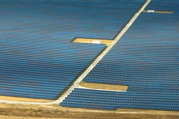 Aerial view of large sustainable electrical power plant with rows of solar photovoltaic panels for producing clean electric energy Concept of renewable electricity with zero emission