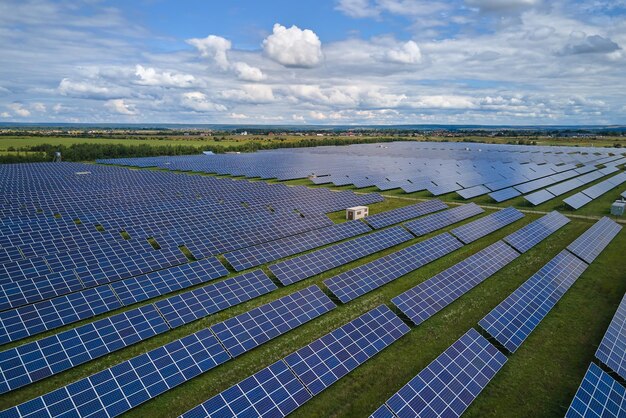 Aerial view of large sustainable electrical power plant with rows of solar photovoltaic panels for producing clean electric energy Concept of renewable electricity with zero emission