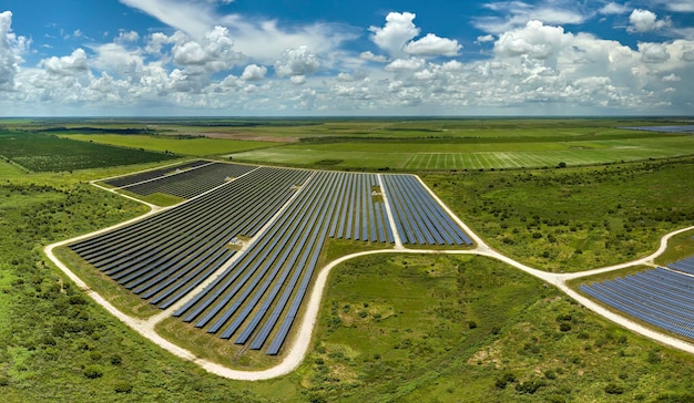 Aerial view of large sustainable electrical power plant with rows of solar photovoltaic panels for producing clean electric energy Concept of renewable electricity with zero emission