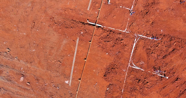 Aerial view laying water pvc plastic pipes and sewer sewage pipes system in ground during plumbing