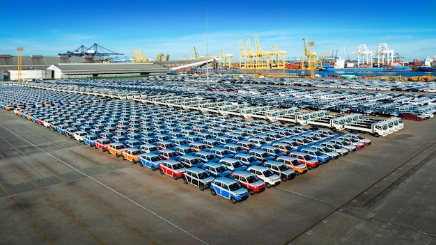 Aerial view a lot of new car for import and export shipping by ship Smart dealership at car depot