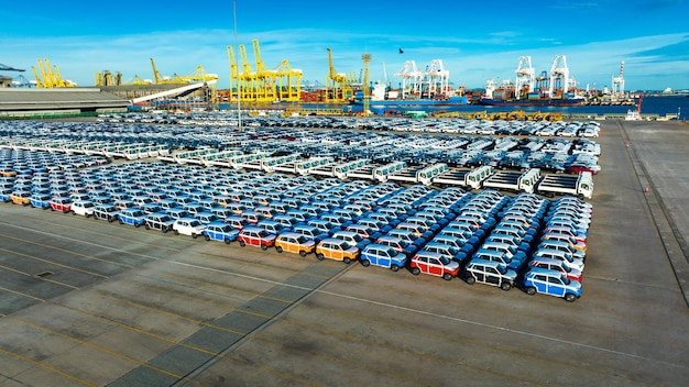 Aerial view a lot of new car for import and export shipping by ship Smart dealership at car depot