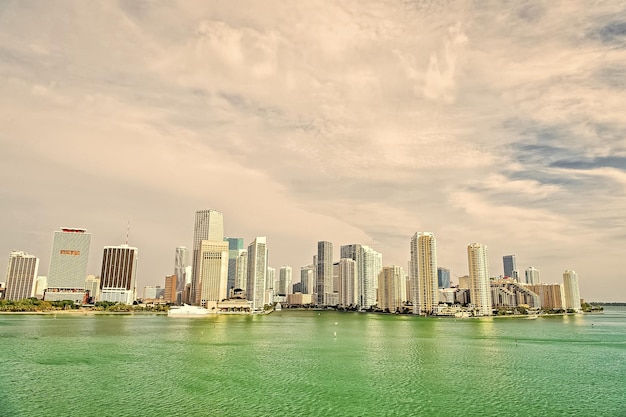 Aerial view of Miami skyscrapers with blue cloudy sky boat sail