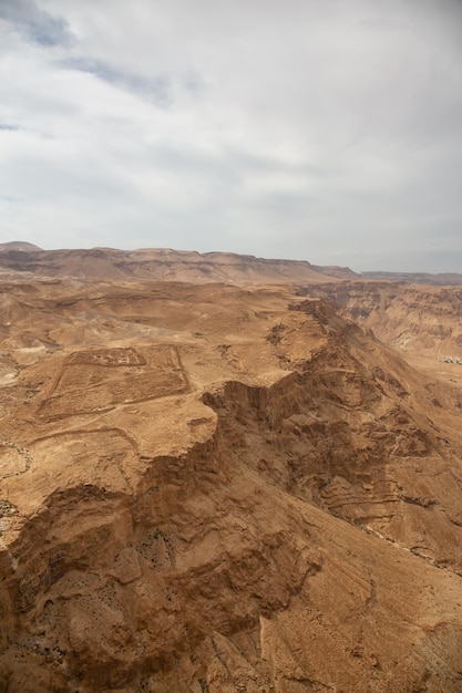 Aerial view of a mountain desert landscape during a cloudy and sunny day