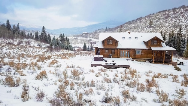 Aerial view of the mountain house covered in snow in the Winter.