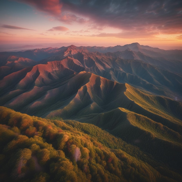 An aerial view of a mountain range at sunset it