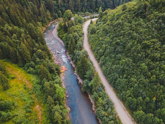 Aerial view of mountain river people rafting in creek. extreme vitality