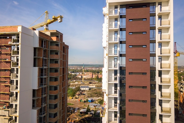 Aerial view of multi storey residential apartment buildings under construction. Real estate development.