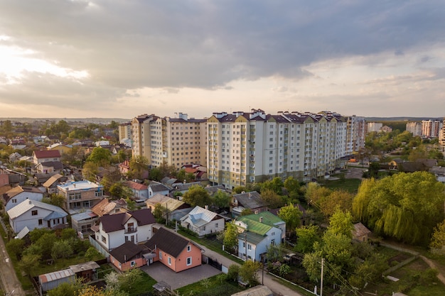 Aerial view of multistory apartment buildings in green residential area.