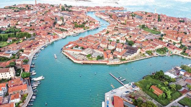 Aerial view of Murano island in Venetian lagoon sea from above, Italy