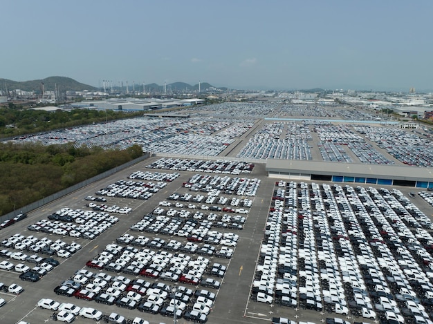 Aerial view of new cars stock at factory parking lot Above view cars parked in a row Automotive