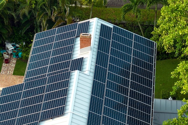 Aerial view of new expensive american building roof with rows of blue solar photovoltaic panels for producing clean ecological electric energy Renewable electricity with zero emission concept