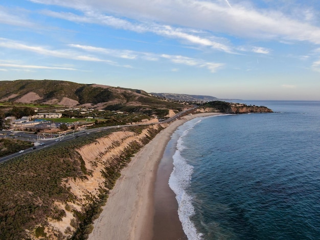 Aerial view of Newport Beach small road next to the cliff during sunset twilight