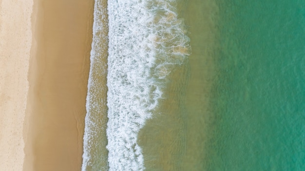 Aerial view of the ocean waves washing on the coast of the Andaman ocean Amazing top down nature Landscape seascape view beautiful for travel background and website.