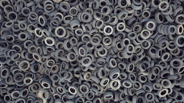 Aerial view of old tires Many car and truck tires on dump site from above