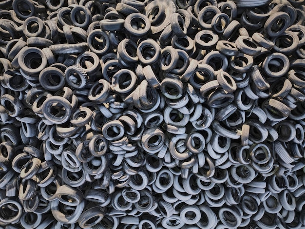 Aerial view of old tires Many car and truck tires on dump site from above