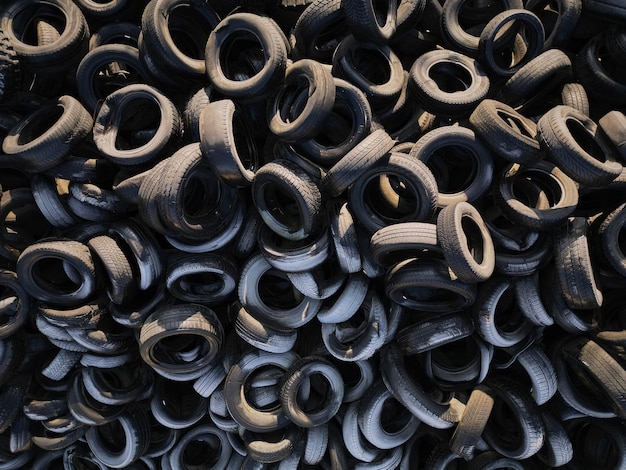 Aerial view of old tires Many car and truck tires on dump site from above