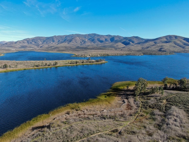 Aerial view of Otay Lake Reservoir with blue sky and mountain on the background, Chula Vista, CA