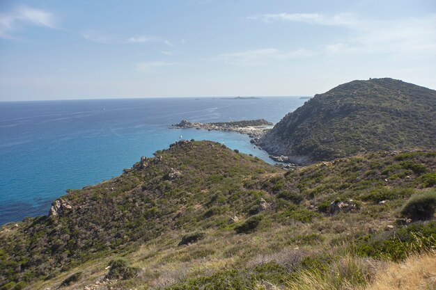 Aerial view of the panorama of a part of the coast of Sardinia overlooking the crystal clear sea

