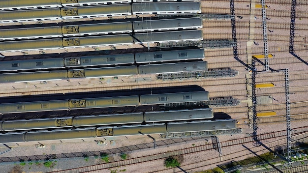 Aerial view over passenger trains in rows at a station