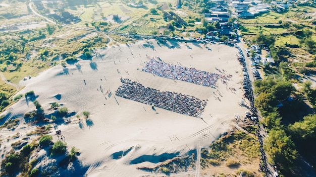 Aerial View People around Parangkusumo sand dunes are praying Eid alFitr in the morning