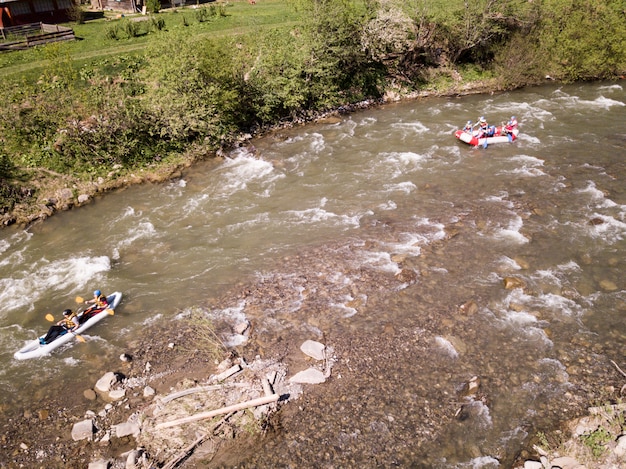 Aerial view of people having fun during rafting in the river