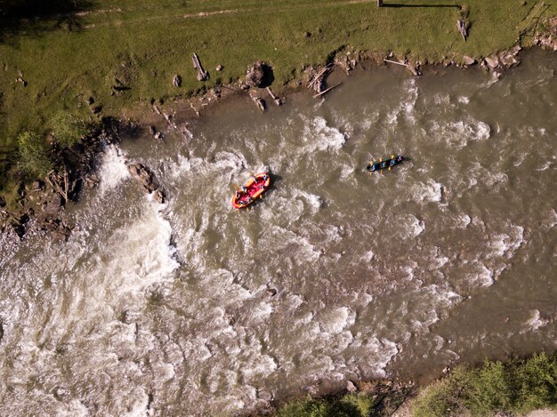 Aerial view of people having fun during rafting in the river