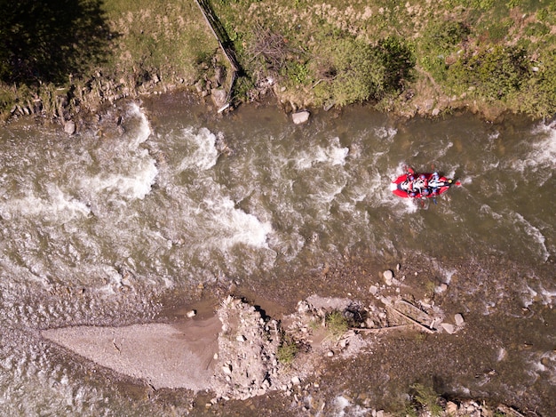 Aerial view of people having fun during rafting in the river