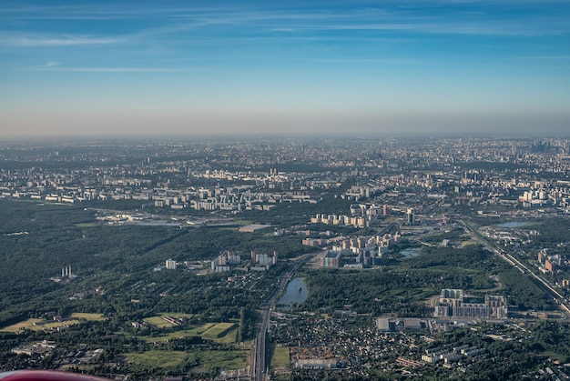 Aerial view photo from airplane of city and clear sky aerial photo of large city from an airplane window view of city of Moscow through window from plane