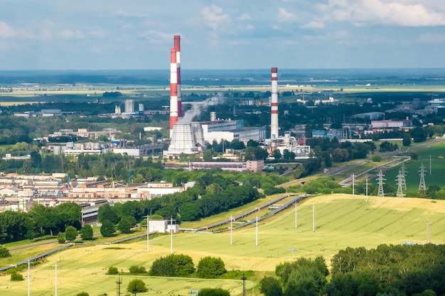 Aerial view on pipes of chemical enterprise plant Air pollution concept Industrial landscape environmental pollution waste of thermal power plant