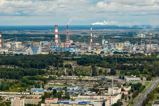 Aerial view on pipes of chemical enterprise plant Air pollution concept Industrial landscape environmental pollution waste of thermal power plant