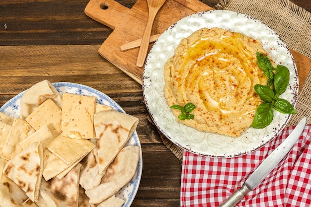 Aerial view of a plate of homemade hummus with pita bread and crackers Healthy and natural food concept