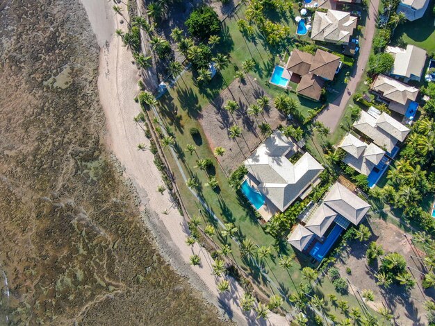 Aerial view of Praia Do Forte coastline beach with villas and pools