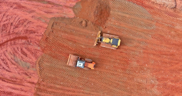 Aerial over view prepare a construction site for a building earth moving the truck and bulldozer preparing ground