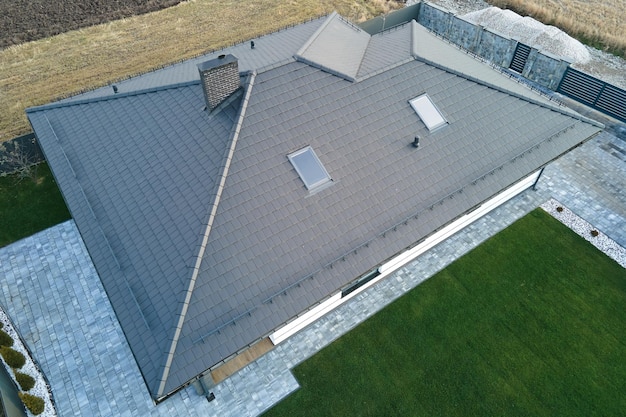 Aerial view of private house with ceramic shingles covered roof top. Investment in real estate concept